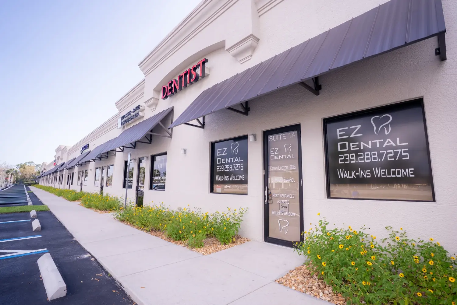 EZ Dental storefront windows with practice signage and phone number in Fort Myers, FL