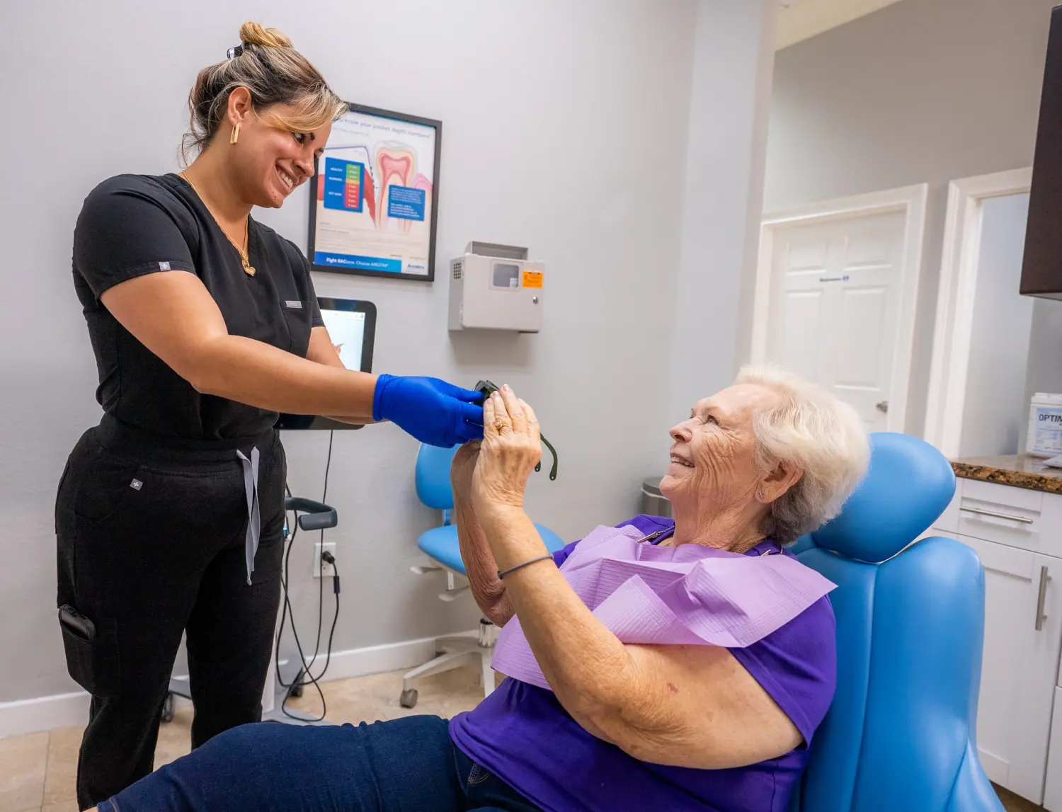 EZ Dental assistant caring for senior patient in dental chair in Fort Myers, FL