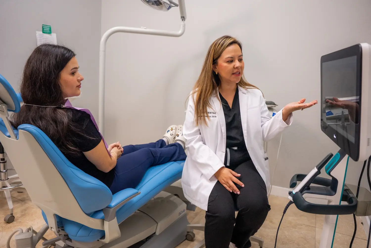 EZ Dental dentist reviewing digital scan results with seated patient in Fort Myers, FL